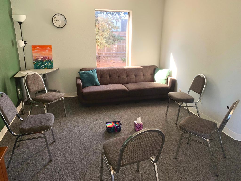 Group therapy room with chairs and a couch formed in a circle